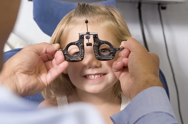 stock image of a young child getting an eye exam