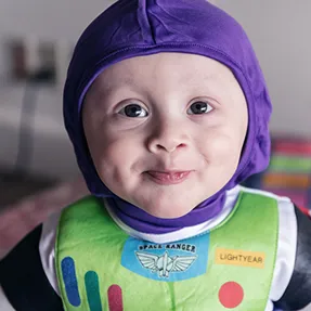 Young boy wearing costume looks straight into camera