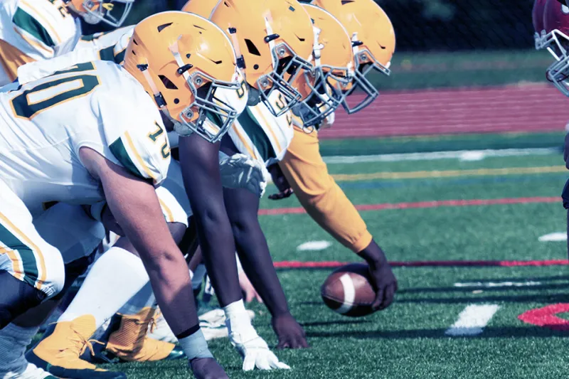 Offensive linemen in position, awaiting a snap