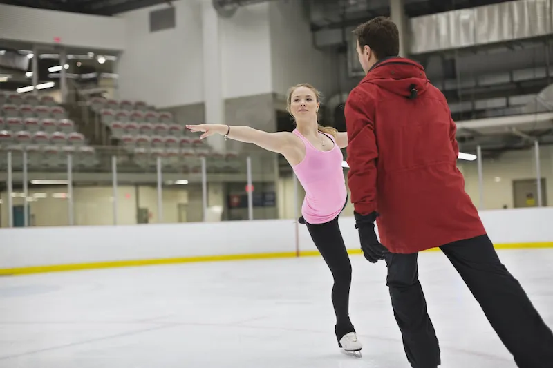Figure skater stretches out while practicing routine