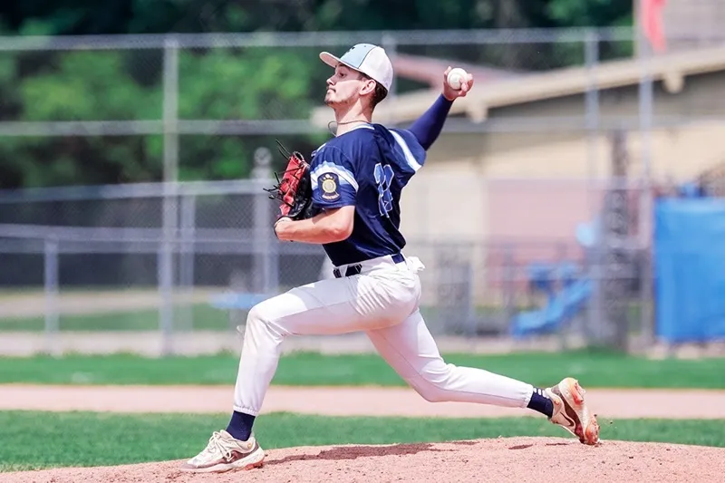 Baseball player throws pitch from mound