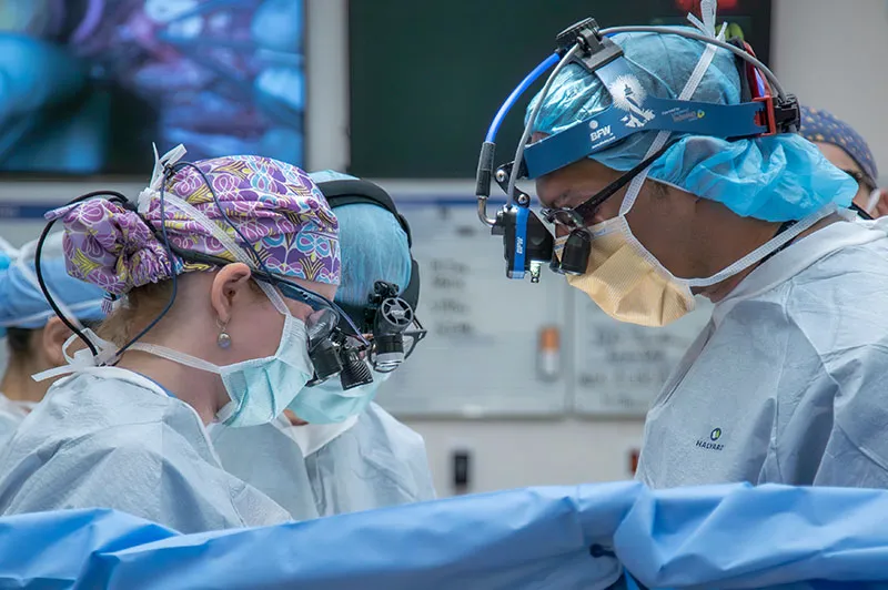 Surgeons and assistants at work in operating room