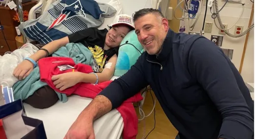 Mike Vrabel sitting next to bed of Boston Children's Hospital patient