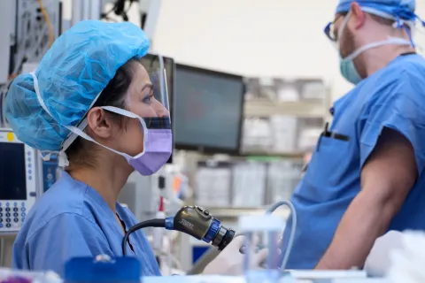 Female clinician looks off to the distance while in operating room
